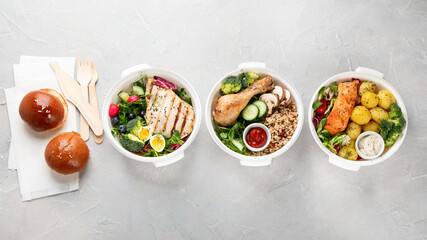 Fototapeta na wymiar Healthy meal prep in lunch boxes on light background.