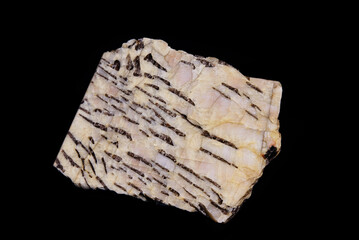 A sample of a granite mineral. Written in granite. A piece of graphic pegmatite stone on a black background.