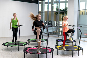 Trampoline for fitness girls are engaged in professional sports, the concept of a healthy lifestyle jumping trampoline woman fitness sport training, from workout active in lifestyle from body trainer - obrazy, fototapety, plakaty
