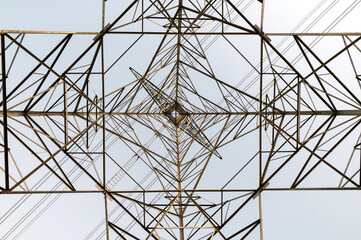 Abstract structure  high voltage transmission tower on sky background.