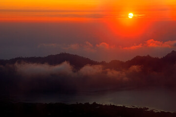 Scenic view of clouds and mist at sunrise from the top of mount Batur (Kintamani volcano), Bali, Indonesia.
