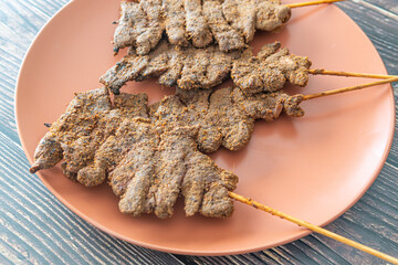 Nigerian spicy grilled Suya snack on a stick ready to eat