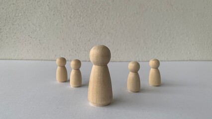 Model wooden doll representing leadership. Leadership and followers concept