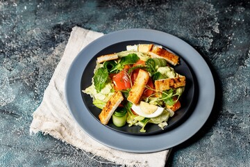 Delicious salad with salmon, vegetables and croutons. Mediterranean Kitchen. Healthy diet