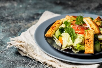 Delicious green salad with salmon, vegetables and croutons. Mediterranean Kitchen. Healthy diet