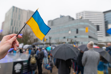 Ukrainian flag on the background of the rally. No war. Support for Ukraine - obrazy, fototapety, plakaty