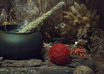 Magic items. Smoking twist of bitter wormwood herb for fumigation in iron cauldron, a ball of red...