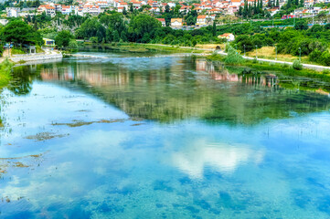 Fototapeta na wymiar River Trebisnjica bank during summer day in Trebinje, Bosnia and Herzegovina.