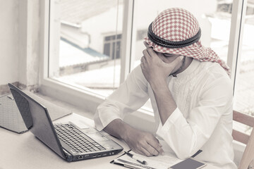 Muslim businessman who sitting at the office in feeling sad because his business failed and unemployed. Business failed concept.