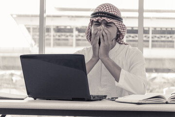 Muslim businessman who sitting at the office in feeling sad because his business failed and unemployed. Business failed concept.