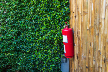 fire extinguisher on bamboo wall