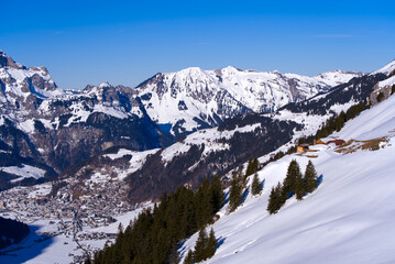 Aerial view of mountain panorama at the Swiss Alps seen from ski resort Engelberg, focus on background. Photo taken February 9th, 2022, Engelberg, Switzerland.