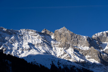 Aerial view of mountain panorama at the Swiss Alps seen from ski resort Engelberg, focus on background. Photo taken February 9th, 2022, Engelberg, Switzerland.
