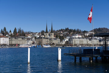 Roman catholic Court Church at City of Luzern on a sunny winter day with lake Luzern in the foreground, focus on background. Photo taken February 9th, 2022, Lucerne, Switzerland.