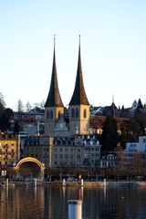 Roman catholic Court Church at City of Luzern on a winter morning with lake Luzern in the foreground. Photo taken February 9th, 2022, Lucerne, Switzerland.
