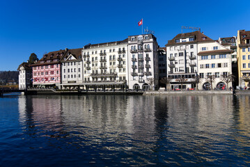 Cityscape of medieval old town of Luzern with river Reuss on a sunny winter day. Photo taken February 9th, 2022, Lucerne, Switzerland.