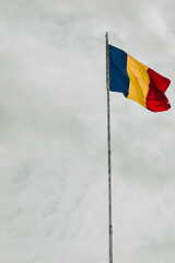 the Romanian flag waving. photo during the day.
