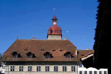 Medieval City Hall with clock tower at the old town of Luzern on a sunny winter day. Photo taken February 9th, 2022, Lucerne, Switzerland.