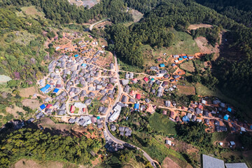Aerial view of local rural village in the valley on faraway at countryside among the tropical rainforest