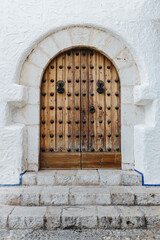 Old wooden door in the old town of Sitges, Spain