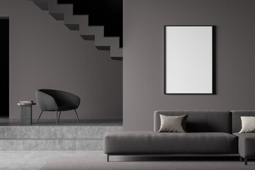 Dark living room interior with empty white framed mockup poster on wall, sofa, stairs, armchair concrete floor. Concept of minimalist design. Creative idea. Mock up. 3d rendering