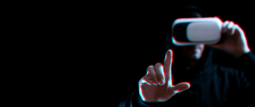 Vr glasses virtual reality. Blured young man in digital headset for virtual reality technology on dark background with glitch effect. Amazing technology, online game, entertainment.