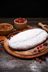 Traditional Christmas stollen cake recipe with ingredients on wooden background