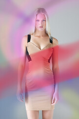 Color perfect. Portrait of an attractive young female wearing a dress with colours floating around her.