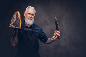 Bearded elderly butcher with knife and meat piece - Powered by Adobe