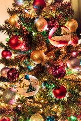 Obraz na płótnie Canvas Colorful baubles hanging on a Christmas tree