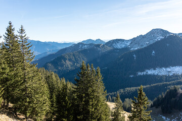 Patches of winter snow on high forested mountains