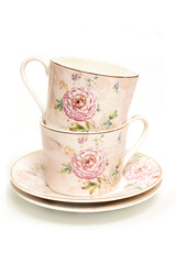 Decorated tea cups on white background