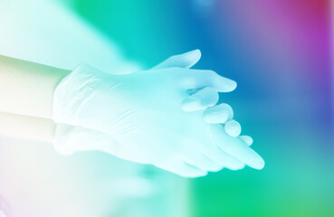 Medical background, hand of medical personnel wearing gloves, medical gloves selective focus, technical spectrum.