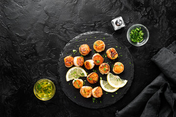 Grilled scallops with creamy lemon spicy sauce on black background. top view - 489663383