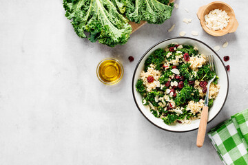 Fresh healthy salad with kale leaves, almond flakes, dried cranberry and quinoa. top view - obrazy, fototapety, plakaty