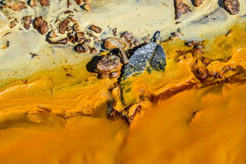 Orange poison from a gold mine - pollution - liquid residues discharged into a lake in Romania,...