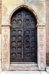 Ornate carved medieval door with metal studs