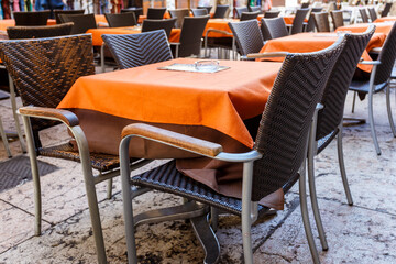 Restaurant tables with bright orange tablecloths