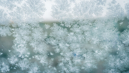 Snow crystals formed on the window during the cold months of winter