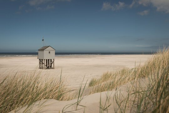 Wooden beach shelter hut on the shore in dunes of Dutch island Terschelling