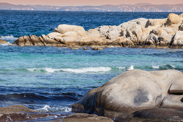 Seascape with a seagull sitting on a rock. A picturesque scene on a windy day - Powered by Adobe