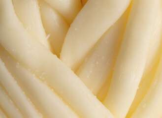 Pigtail of cheese as an abstract background.