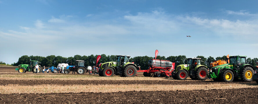Belogorye, Khmelnytsky region, UKRAINE - August 19, 2021: tractors with seeders, plow, harrows at the demonstration of agricultural machinery, exhibition "Battle of agrotitans" seeder competition