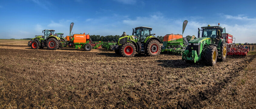 Bilogirya, Khmelnytsky region, UKRAINE - August 19, 2021: tractors with seeder at the demonstration of agricultural machinery, exhibition "Battle of agrotitans" seeder competition
