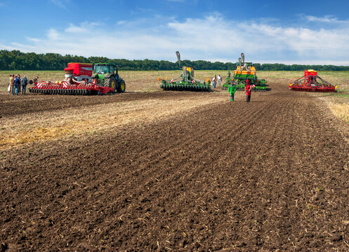 Bilogirya, Khmelnytsky region, UKRAINE - August 19, 2021: tractors with seeder at the demonstration of agricultural machinery, exhibition "Battle of agrotitans" seeder competition, plowed soil