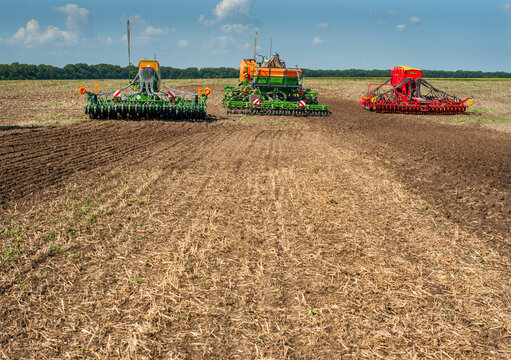 Bilogirya, Khmelnytsky region, UKRAINE - August 19, 2021: tractors with seeder at the demonstration of agricultural machinery, exhibition "Battle of agrotitans" seeder competition, plowed soil