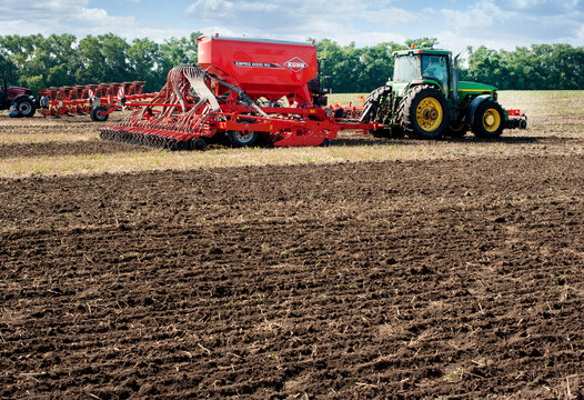 Bilogirya, Khmelnytsky region, UKRAINE - August 19, 2021: Tractor with seeder Kuhn espro 6000RC with fertilizer function and seeding control system.