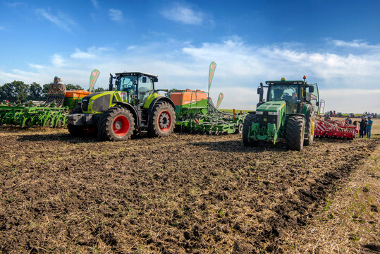 Bilogirya, Khmelnytsky region, UKRAINE - August 19, 2021: tractors with seeder at the demonstration of agricultural machinery, exhibition "Battle of agrotitans" seeder competition