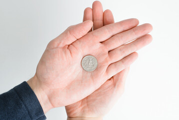Business concept, financial problems, poverty, poor, crisis. Top view quarter dollar coin on palm, man holds money in his hands