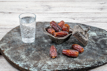 Ramadan concept: Dates, zam zam water on a wooden table